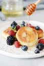 Sunday breakfast with cheesecake, honey, fresh berries and mint. Cottage cheese pancakes