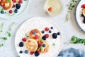 Sunday breakfast with cheesecake, honey, fresh berries and mint. Cottage cheese pancakes Royalty Free Stock Photo