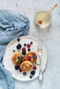 Sunday breakfast with cheesecake, honey, fresh berries and mint. Cottage cheese pancakes Royalty Free Stock Photo