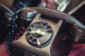 Old worn black phone on counter in sunday flea market. Royalty Free Stock Photo