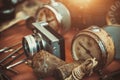 Retro alarm clocks, camera and rusty plumb bob on countertop in sunday flea market. Royalty Free Stock Photo