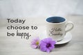 Sunday inspirational quote - Today choose to be happy. With hello Sunday greeting on cup of morning coffee and purple flower.