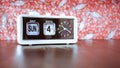 Sunday 4th of the month - white vintage alarm clock with date and time on retro background