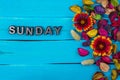 Sunday word on blue wood with flower Royalty Free Stock Photo