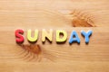 Sunday word written with colorful letters on wooden table background Royalty Free Stock Photo
