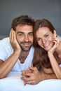 On Sundays we belong in the bedroom. a happy young couple relaxing in bed together at home. Royalty Free Stock Photo