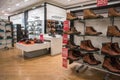 Interior of mens menswear fashion footwear department in large shop store showing reduced items on a sale