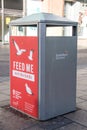 Litter bin with `Feed Me not the Birds` poster Royalty Free Stock Photo