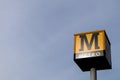 Metro sign on a tall pole with the sky behind it. Tyneside metro