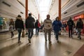 People shoppers inside a modern shopping centre mall walking