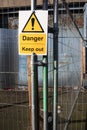 Yellow Danger Keep Out sign on metal wire construction site fence Royalty Free Stock Photo