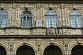 Sundial in cloister. Stone walls, green wood windows, archs and details. Santiago de Compostela. Spain.