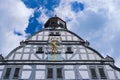 Sundial on the facade of a beautiful blue half-timbered house