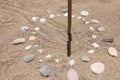 Sundial made of stones on sand closeup background