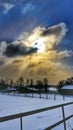 Sundog in clouds during snowfall