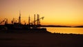 Sundown with shadows of Cranes and boats on the shore of Croatia Royalty Free Stock Photo