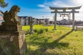 At sundown, komainu and torii gate at the site of the annual Okaeri Welcome Home festival, Mikawa, Japan. Royalty Free Stock Photo