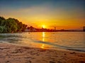 Sundown  sover the natural sand beach shore at the riverside of the river Rhein in Cologne Royalty Free Stock Photo