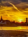 Sundown sover the natural sand beach shore at the riverside of the river Rhein in Cologne Royalty Free Stock Photo