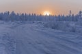 Sundown and sunrises. Winter landscape. Orange sky and silhouettes of trees on the background of heaven. Frosty evening, snow arou Royalty Free Stock Photo