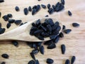 Sunflower Black Seeds in Wooden Spoon and Table Close Up Royalty Free Stock Photo