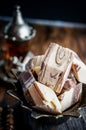 Sunflower halva in the national Turkish dish on a wooden background. Festive Oriental delicacy with tea. Dead life. Close up Royalty Free Stock Photo