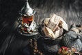 Sunflower halva in the national Turkish dish on a wooden background. Festive Oriental delicacy with tea. Stilllife. Copy space