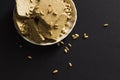 Sunflower halva with seeds on plate, on black background Royalty Free Stock Photo