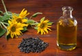 Sunflower oil in a glass bottle and a handful of sunflower seeds on the background of sunflowers Royalty Free Stock Photo