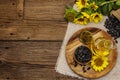 Sunflower oil in glass cruet with flower head and seeds in wooden bowl Royalty Free Stock Photo