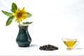 Sunflower oil in a glass gravy boat, a bunch of sunflower seeds and a sunflower with a fly in a vase. Isolated on the white backgr Royalty Free Stock Photo