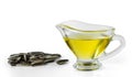 Sunflower oil in a glass gravy boat and a handful of sunflower seeds isolated on a white Royalty Free Stock Photo