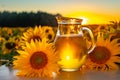 Sunflower oil in a glass jug on a background of sunflowers Royalty Free Stock Photo