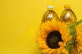 Sunflower oil. Oil bottles and sunflowers blooming on a yellow background.Organic farm sunflower oil. Edible oils.top Royalty Free Stock Photo