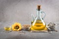 Sunflower oil and sunflower seeds on dark concrete background with copyspace Royalty Free Stock Photo