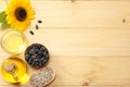 Sunflower oil, seeds and flower on light wooden background. top view with copy space Royalty Free Stock Photo