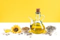 Sunflower oil and sunflower seeds on white and yellow background with copyspace Royalty Free Stock Photo