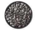 Sunflower seeds in a black plate isolated on white background. top view Royalty Free Stock Photo