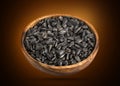 Sunflower seeds in bowl on black background Royalty Free Stock Photo