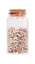 Sunflower seeds in a glass bottle with cork stopper, isolated on Royalty Free Stock Photo