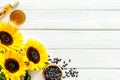 Sunflower with seeds and oil frame on white wooden background top view copyspace Royalty Free Stock Photo