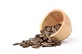 Sunflower seeds pouring from wooden bowl Royalty Free Stock Photo