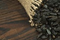 Sunflower seeds are scattered on homespun fabric with a rough texture. close-up, selective focus Royalty Free Stock Photo