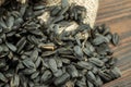 Sunflower seeds are scattered on homespun fabric with a rough texture. close-up, selective focus Royalty Free Stock Photo