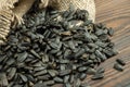 Sunflower seeds are scattered on homespun fabric with a rough texture. close-up, selective focus Royalty Free Stock Photo