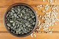 Sunflower seeds in the small bowl on the wooden background Royalty Free Stock Photo