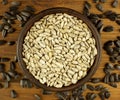 Sunflower seeds in the small bowl on the wooden background Royalty Free Stock Photo