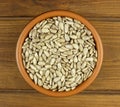 Sunflower seeds in the small bowl on the wooden background Royalty Free Stock Photo