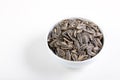 Sunflower seeds in white bowl on white background. Salted sunflower seeds in bowl. Royalty Free Stock Photo