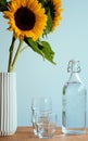 Sunflowers, drinking glasses and water carafe